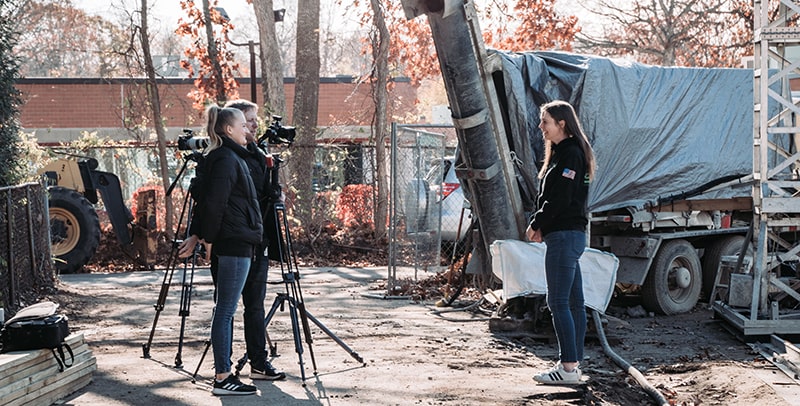 Female SQ4D employee being interviewed on the news